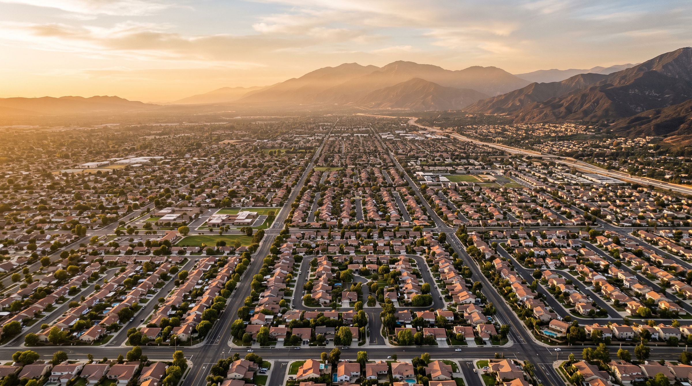 Aerial view of Inland Empire neighborhoods with the San Bernardino Mountains beyond